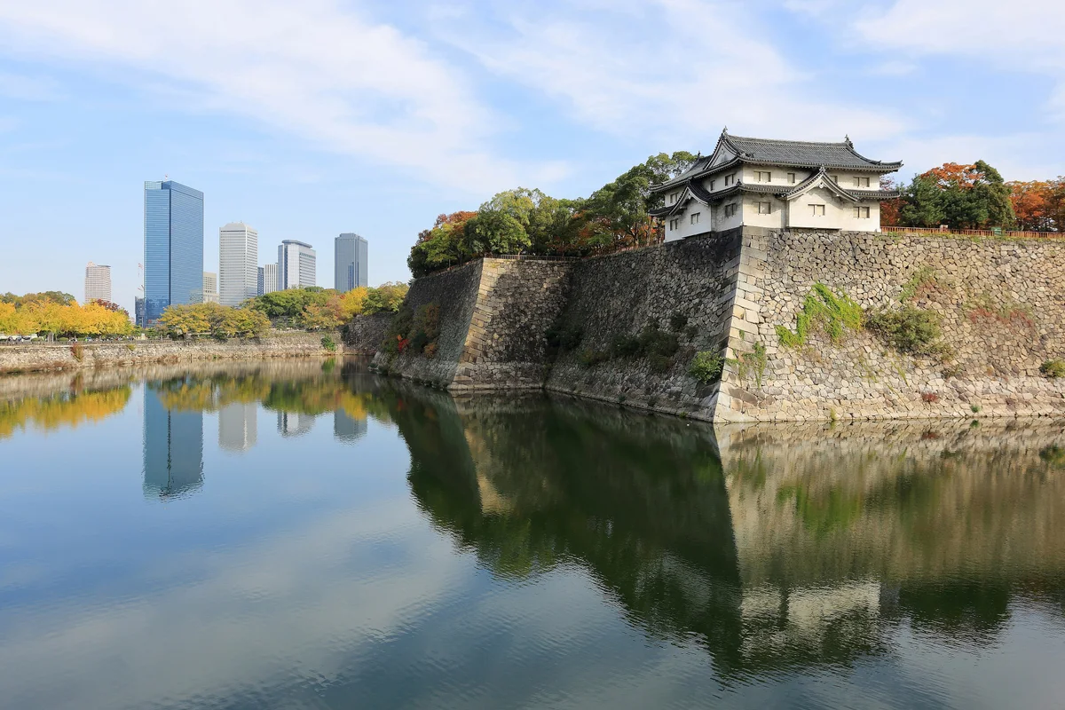 Osaka Castle's main tower rising above its stone walls and moat